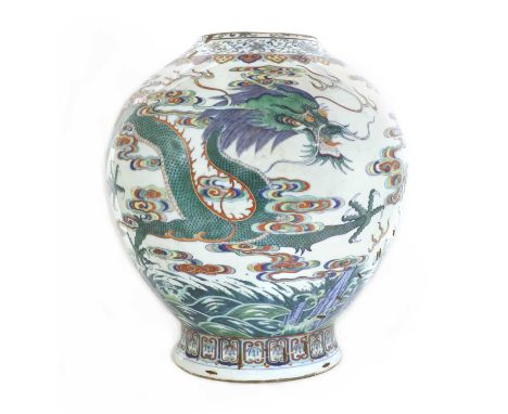 A Chinese doucai vase,Qing dynasty (1644-1911), of baluster form, painted with dragons among waves and clouds, between scroll