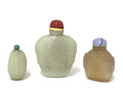 A Chinese jade snuff bottle,Qing dynasty (1644-1911), of compressed tapering form, flanked by mask and ring handles to the si