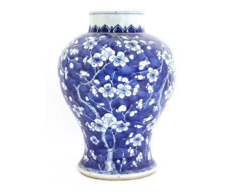 A Chinese blue and white vase, Kangxi (1662-1722), of baluster form, painted with blossoming prunus branches against a crackl