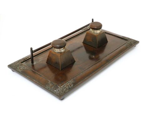 A Chinese hardwood inkstand,early 20th century, of rectangular form on four ball feet, carved with blossoming prunus branches