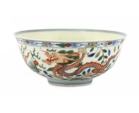 A Chinese wucai bowl,20th century, the rounded sides rising from a tapering circular foot to a flared rim, painted with drago