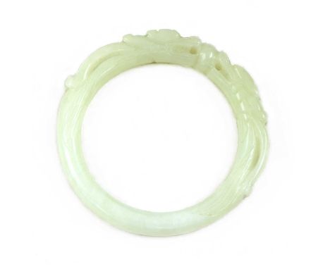 A Chinese jade bangle,Qing dynasty (1644-1911), carved with a pair of confronting dragons, the stone of greyish-celadon tone,