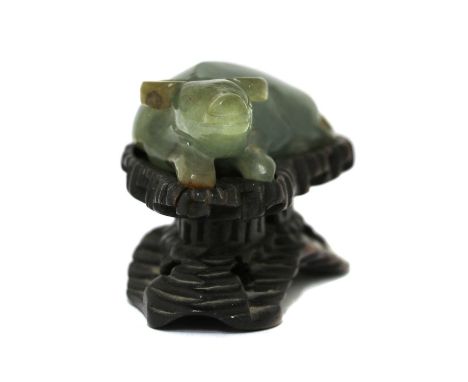 A Chinese jade carving, late Qing dynasty, of a recumbent buffalo, 6cm long, wood stand (2)Condition report: Wood stand with 