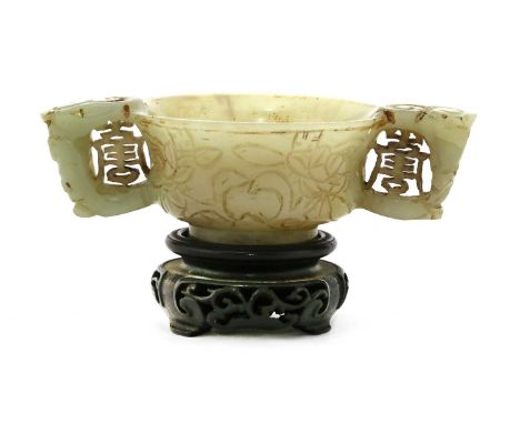 A Chinese jade cup, Ming dynasty (1368-1644), the waisted body rising from a splayed circular foot to a flared rim, incised w