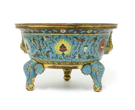 A Chinese cloisonné censer,the rounded sides rising to a flared flat rim with two Buddhist lion handles, supported by three e