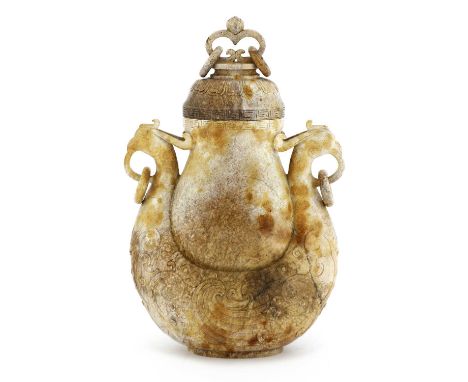 A Chinese jade vase and cover, of baluster form with a key fret border to the rim, supported by two addorsed phoenixes, each 