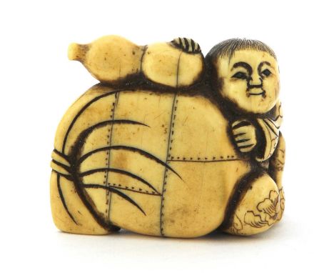 A Japanese ivory netsuke, Meiji period (1868-1912), of a boy holding a cloth sack and a double gourd, 4cm longCondition repor