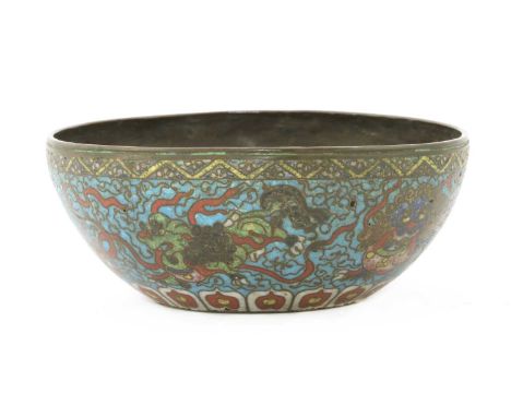 A Chinese cloisonné bowl, late Ming dynasty, the rounded sides rising from a concave base, enamelled on a blue ground with Bu