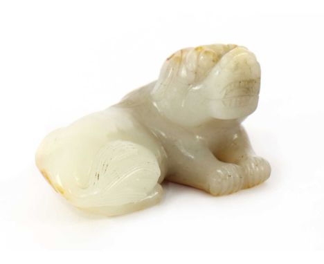 A Chinese jade carving, of a recumbent dog, the stone with russet inclusions, 6.5cm longCondition report: A minute chip to th