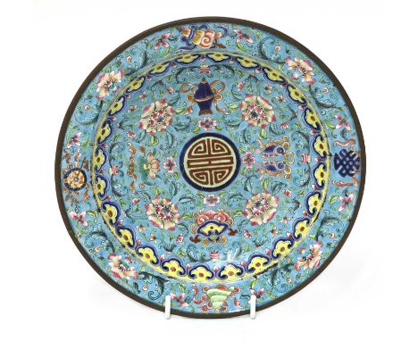 A Chinese Canton painted enamel dish, Qing dynasty (1644-1911), the rounded sides rising from a circular foot to a flat rim, 