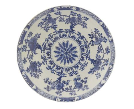 A Chinese blue and white charger,Kangxi (1662-1722), the rounded sides rising from a channelled foot ring, the centre painted