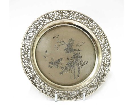 A Chinese export silver salver,early 20th century, of circular form with a pierced border, with birds among blossoming prunus