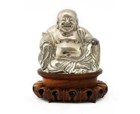 A Chinese export silver model of Budai,early 20th century, the smiling immortal seated wearing a flowing loose robe open to t