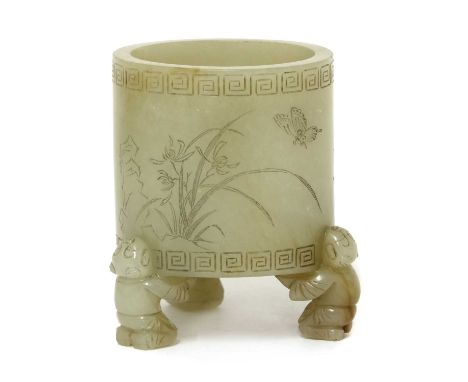 A Chinese jade censer, of cylindrical form supported by three boys, carved with a butterfly above flowers, inscribed, 6.3cm h