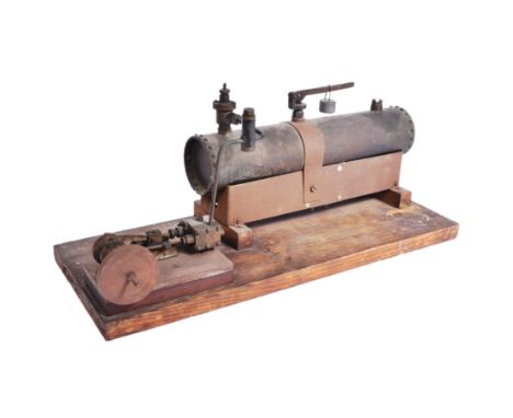 Live Steam - a hand built scratch built stationary steam model with a large cylindrical boiler and fly wheel, mounted onto a 