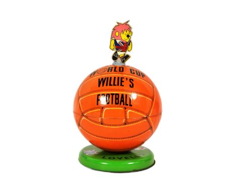 An original vintage 1960s Lovells tinplate World Cup Willie toffee tin, designed as a football surmounted by a World Cup Will