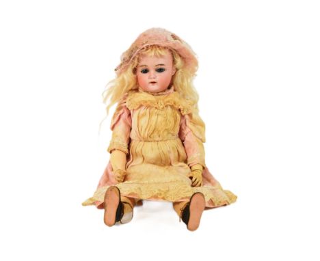 An early 20th Century German Simon &amp; Halbig bisque headed doll. Blue flirty eyes with finely painted brows and lashes, pi
