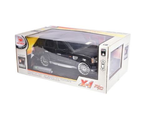 An original New Bright made RC Radio Control model Range Rover car with rechargeable 9.6V battery, battery charge and transmi