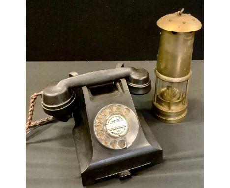 A mid 20th century black Bakelite telephone, 332, PL 57/;  a miners lamp 