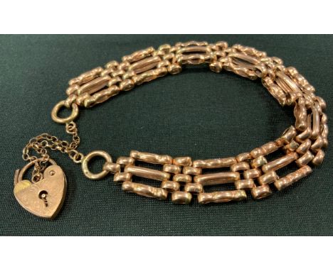 A 9ct rose gold fancy link gate bracelet, padlock clasp, 17.5g gross 
