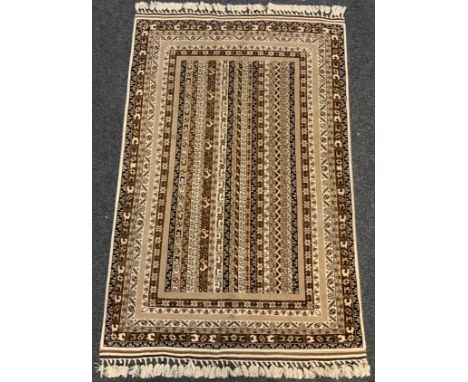 A fine hand-made Telle Turkaman rug / carpet, woven in muted tones of umber, brown, and cream, 190cm x 125cm. 