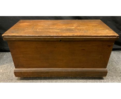 A stained pine tool chest, hinged top, drop loop handles, castor feet, 51cm high, 94cm wide, 46cm deep. 
