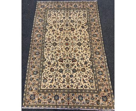 A fine Persian Kashan rug / carpet, woven with a dense field of stylised floral motifs, in shades of pale blue, red, and deep