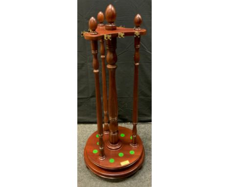 A mahogany revolving snooker cue stand, fitted for nine cues, rests, turned supports, circular base, retailed by Birmingham B