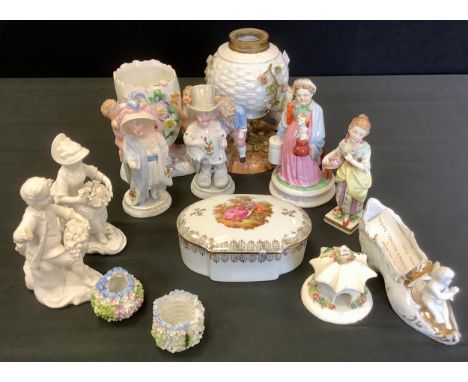 A German figural oil lamp, c.1880;   a pair of German figures, Papa and Mama;  a pair of Derby figures, in the white, Flower 