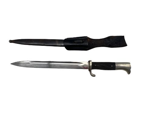 German Carl Eickhorn Solingen bayonet with two piece chequered grip and scabbard, squirrel mark, blade length 26cm