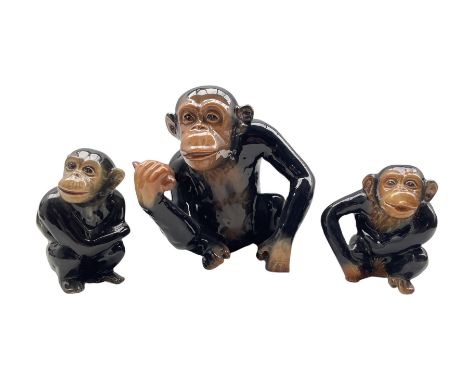 Sylvac model of a seated monkey holding a piece of fruit H17cm and two smaller Sylvac monkeys 