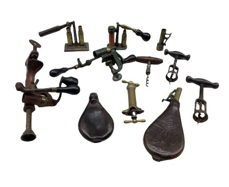 Various shotgun cartridge re-loading tools, two leather bodied powder flasks and three vintage corkscrews