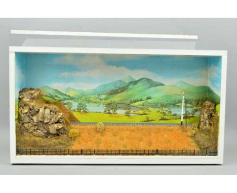 A CASED OO GAUGE MODEL RAILWAY DIORAMA, low relief model of single track on an embankment, emerging from a tunnel contained i