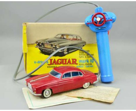 A BOXED LINCOLN INTERNATIONAL PLASTIC BATTERY OPERATED JAGUAR MARK 10 SALOON, No.7010, maroon plastic body with blue glazing 
