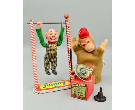 AN ARNOLD TINPLATE JIMMY ACROBATIC CLOWN, plastic doll missing one hand and has some damage to clothing, some damage and wear