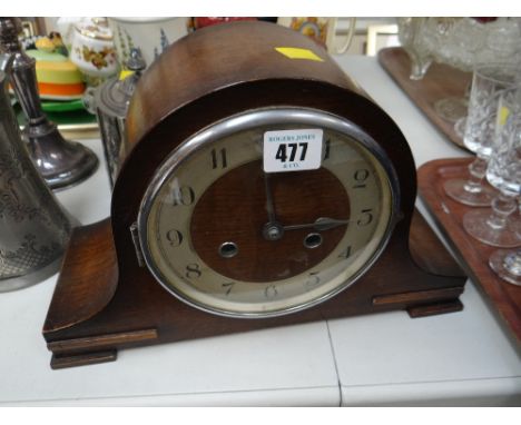 An oak cased dome top mantel clock