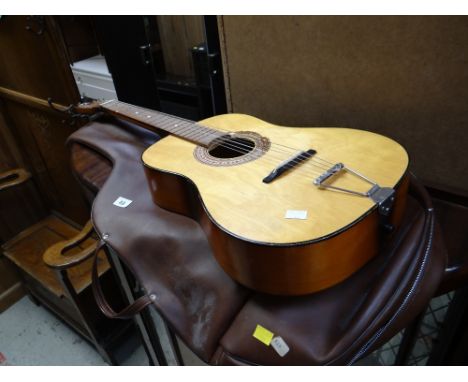 A vintage cased acoustic guitar