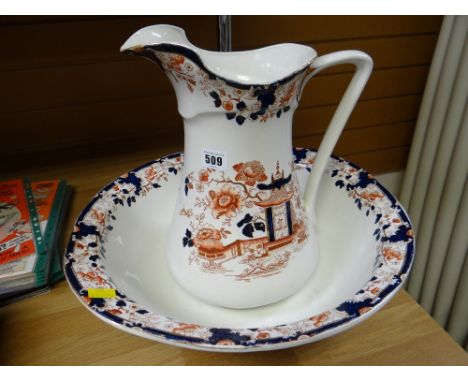 A large pottery jug & basin set with an Oriental red & blue design