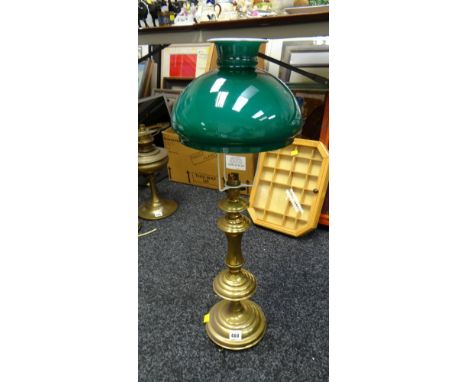 A brass table lamp with shade