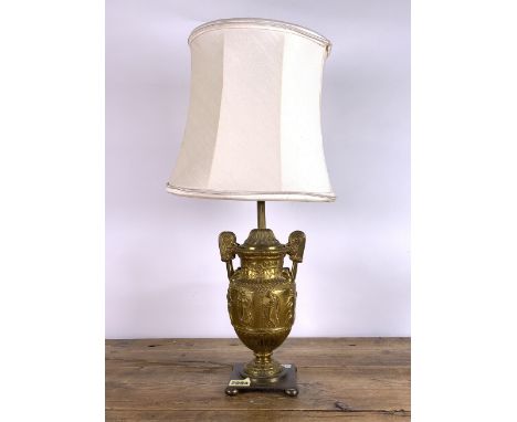 A VICTORIAN STYLE BRASS TABLE LAMPFormed as a urn decorated with classical figures, 52cm high