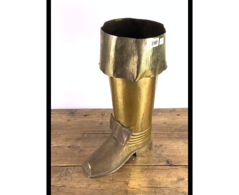 AN EARLY 20TH CENTURY BRASS STICK STANDFormed as a boot, 28cm wide; 45cm high