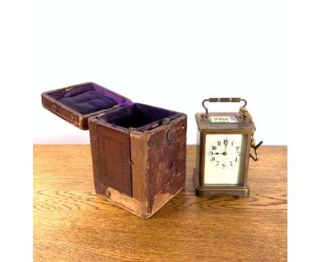 A 19TH CENTURY BRASS CASED CARRIAGE CLOCK, IN LEATHER CASE.The clock 9cm wide x 12cm highProvenance: Shakenhurst Hall, Cleobu