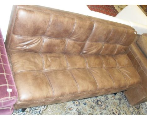 A modern brown leather effect sofa bed, raised on a metal frame