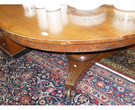 A William IV mahogany breakfast table, the circular top with plain frieze on a tapered faceted octagonal pedestal to tripod p