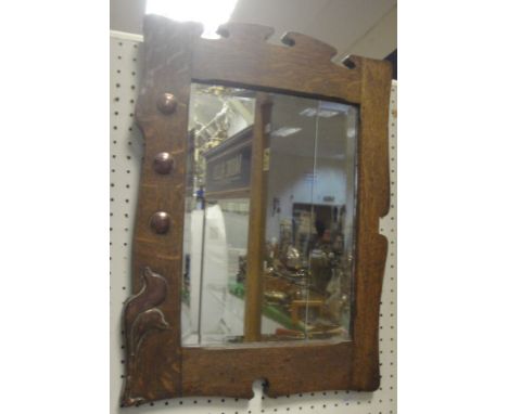 A circa 1900 oak framed and copper mounted Arts & Crafts style wall mirror with bevel edged plate, together with an oak cased