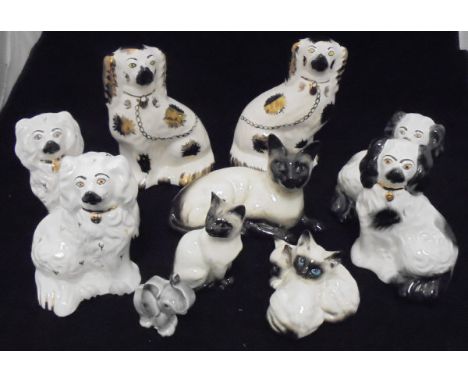 A pair of Beswick "Staffordshire spaniel figures" (1378/6), a pair of Royal Doulton Staffordshire spaniel figures (1378/6), a