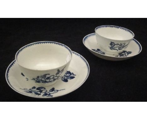 Two late 18th Century English blue and white pottery tea bowls and saucers with floral spray and strawberry pattern, (one pro
