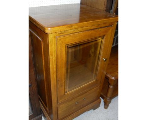 A modern oak two door display case with leaded glass and mirrored back together with a further oak cupboard, the single door 