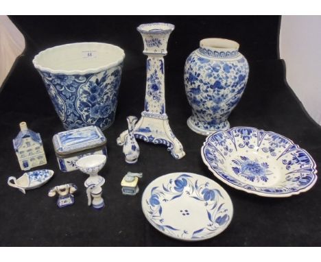 A Delft floral decorated bucket shaped vase, Delft blue and white candlestick, tin glazed baluster shaped vase, Delft blue an