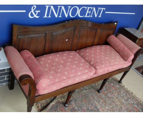 A mahogany framed Georgian style sofa with scrolled arms and pink ground upholstery